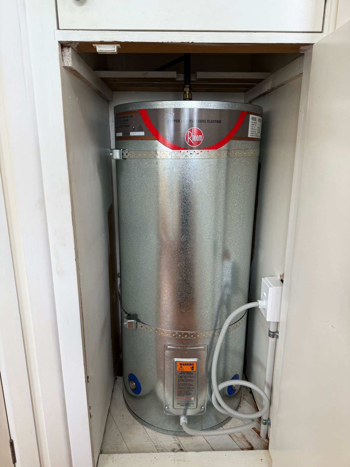 Rheem low pressure copper electric hot water cylinder in cupboard